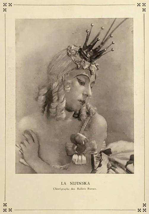 Sepia tone photograph of a woman's head and shoulders. Her hair, or wig is blonde and she is wearing a small crown prop. The text belwo says